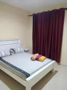 a bed with two pillows on it in a room at Casa Familiar Pôr do Sol in Ribeira Grande