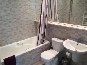 a bathroom with a toilet and a sink at The Kapitani Residence in Nicosia +14 photos