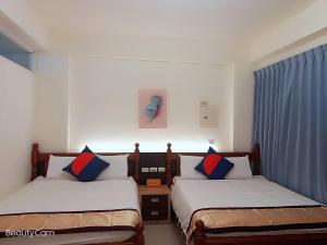 Postel nebo postele na pokoji v ubytování 墾丁慕欣旅店