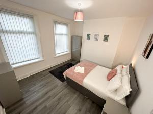 ein Schlafzimmer mit einem Bett und einem Sofa darin in der Unterkunft Spacious Five Bed Home in Liverpool