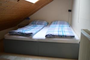 two beds sitting on top of a bed in a room at Ferienwohnung unterm Horn in Immenstadt im Allgäu