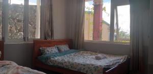 Postel nebo postele na pokoji v ubytování Trăng Non House