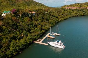 two boats are docked at a dock in the water at Marina del Sol Resort & Yacht Club in Busuanga