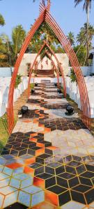 an archway with tables and chairs at a wedding at Marari Sailor Homes in Shertallai