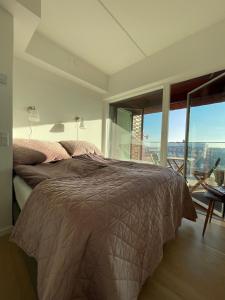 a bedroom with a bed and a large window at ApartmentInCopenhagen Apartment 1527 in Copenhagen