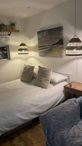 a bedroom with a bed with two pillows on it at Sunnyside at Scurlage Farm in Swansea