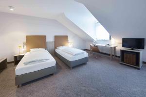 Postel nebo postele na pokoji v ubytování GHOTEL hotel & living Kiel
