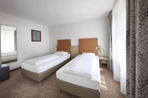 Postel nebo postele na pokoji v ubytování GHOTEL hotel & living Kiel