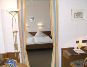 um quarto de hotel com uma cama numa porta em Lessinghof em Braunschweig