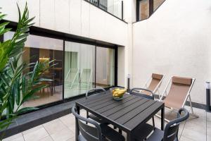 a black table and chairs on a patio at Feelathome Ventas Suites in Madrid