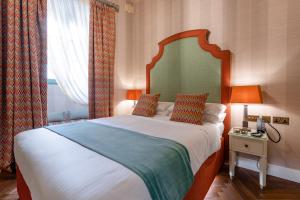 a bedroom with a large bed with a large mirror at Palazzo Bifora Mdina in Mdina +79 photos