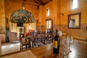 a bottle of wine on a wooden table in a room at 4 bedrooms villa with private pool furnished garden and wifi at Algarinejo in Algarinejo