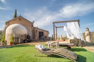 a field of grass with a bed and a tent at 4 bedrooms villa with private pool furnished garden and wifi at Algarinejo in Algarinejo