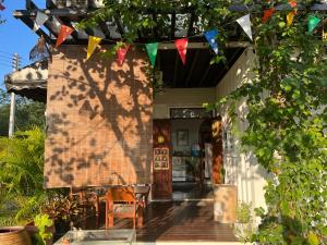 a house with a string of flags on a porch at บ้าน guh (กูว์) in Uthai Thani