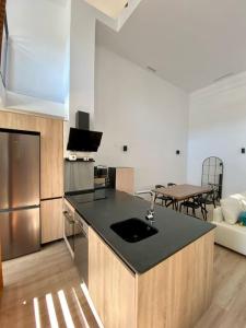 cocina con encimera negra en una habitación en WeRentVLC - Amazing Duplex Loft 2 bdrm en Valencia