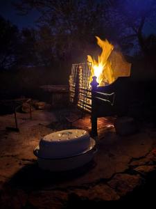 a fire burns in a pot with a flame at Wolverfontein Karoo Cottages in Ladismith