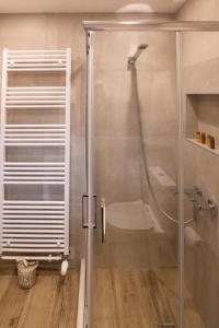 a shower with a glass door in a bathroom at Villa MYLOS Kalavrita in Kalavrita