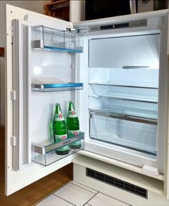 an open refrigerator with two soda bottles in it at Ferienwohnung Haus Gänseplatz in Volkach