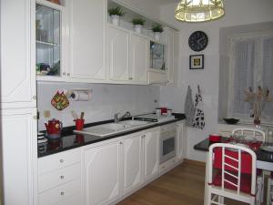 a kitchen with white cabinets and a sink at Casa Vacanze Pietro al Vaticano in Rome +25 photos
