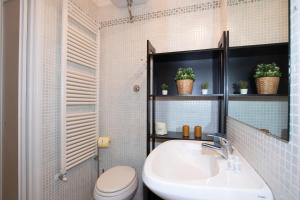 a bathroom with a sink and a toilet at Casato19 - Due passi da Piazza del Campo - NaonBnB in Siena +21 photos