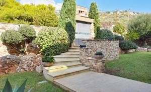A garden outside Luxurious Villa Dionysus with a swimming pool and sea view