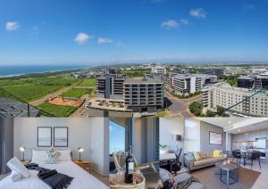 a hotel room with a bed and a view of a city at Umhlanga Arch Luxury Holiday or Work with Sea View - Inverter Backup Power in Durban