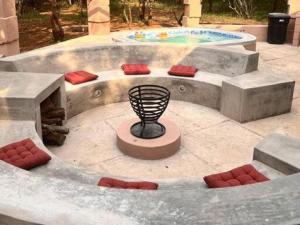a concrete patio with a bench and a pool at Dream Inn in Marloth Park