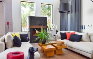 A television and/or entertainment centre at Luxurious Villa Dionysus with a swimming pool and sea view