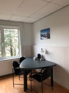 a room with a table and chairs and a window at Vredig Toeven in Klaaswaal
