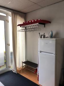 a kitchen with a white refrigerator and a shelf at Vredig Toeven in Klaaswaal +18 photos