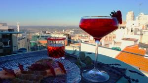 a glass of wine and a plate of food on a table at Hotel Indigo Madrid - Gran Vía by IHG in Madrid