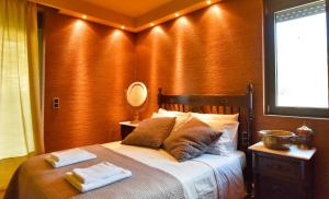 A bed or beds in a room at Luxurious Villa Dionysus with a swimming pool and sea view