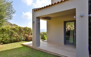 A garden outside Luxurious Villa Dionysus with a swimming pool and sea view