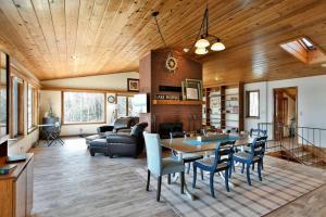 a living room with a table and chairs at Bark Point Retreat in Herbster