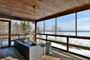 a screened in porch with a view of the ocean at Bark Point Retreat in Herbster