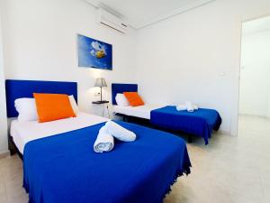 Ein Bett oder Betten in einem Zimmer der Unterkunft La Manga Norte Villa - 6509