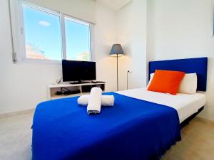 Ein Bett oder Betten in einem Zimmer der Unterkunft La Manga Norte Villa - 6509
