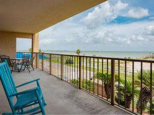 a balcony with chairs and a view of the beach at Laguna Reef #214 - Retreat on Rockport Bay in Rockport