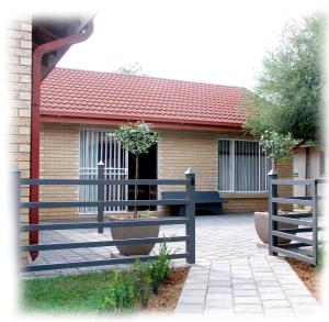 a house with a fence in front of it at Vita Nova in Bloemfontein