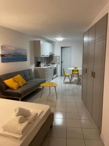 a living room and kitchen with a couch and a table at Hersonissos centre small apartment in Hersonissos