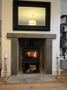 a fireplace in a living room with a mirror at 3bed-Exec Long Say-Walking-Dogs-Pendle Hill - COLNE in Colne