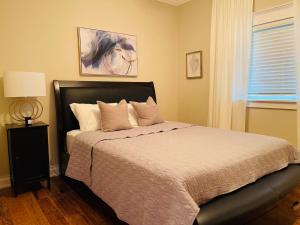a bedroom with a bed and a window at SouthLake Cottage on The Lake. in Washago