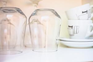 two clear glass containers sitting on a counter at Porto Roma Seaside Studios in Vasilikos