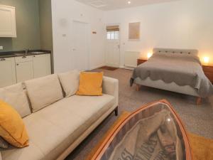 a living room with a couch and a bed at Cheviot View in Cornhill-on-tweed