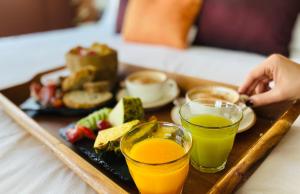 a tray of food with two glasses of orange juice at Hotel Indigo Madrid - Gran Vía by IHG in Madrid