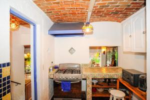 a kitchen with a stove and a counter top at Casa Aurora in Ajijic