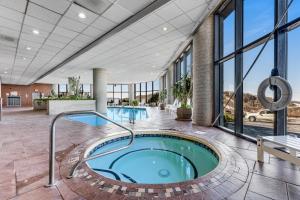an indoor hot tub in a building with windows at Sunset Ridge in Sugar Mountain