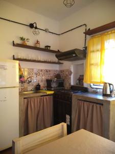 a kitchen with a refrigerator and a stove top oven at Casa Keon in Villa Allende