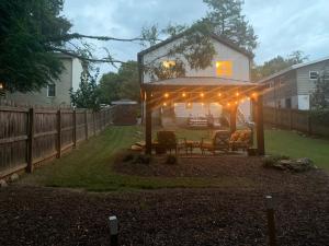 a gazebo with lights on it in a yard at The Popular Pad in Downtown Raleigh, NC in Raleigh