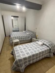 a bedroom with two beds and a mirror at Lila House in Turin